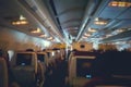 BlurÃ¢â¬â¹ backgroundÃ¢â¬â¹ ofÃ¢â¬â¹ Airplane cabin at night time, dark plane economy class cockpit with seats front view. FullÃ¢â¬â¹ Royalty Free Stock Photo